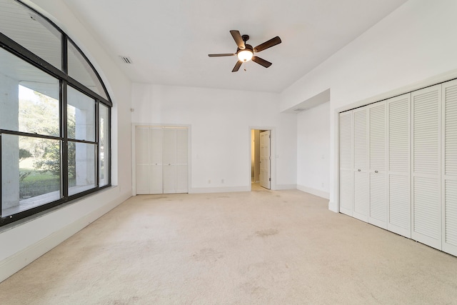 unfurnished bedroom featuring ceiling fan and light colored carpet