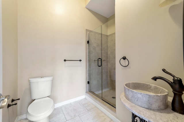 bathroom featuring toilet, tile floors, an enclosed shower, and sink