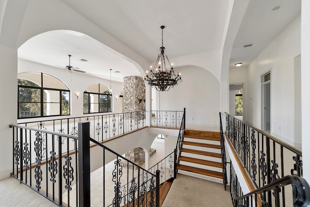 corridor featuring a chandelier and light colored carpet