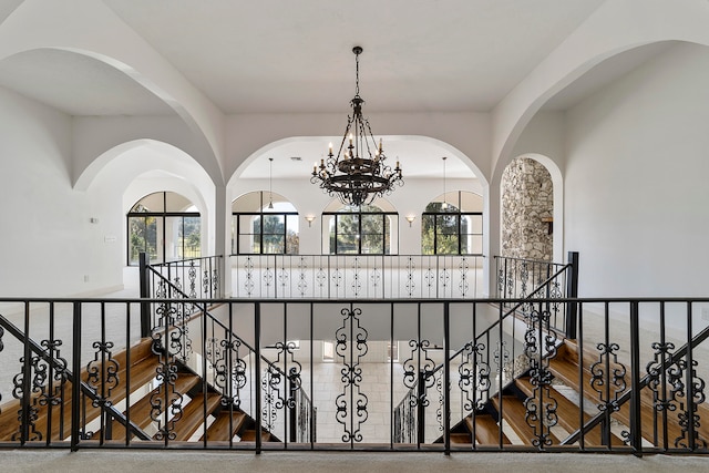 corridor featuring a chandelier, dark hardwood / wood-style floors, and a healthy amount of sunlight