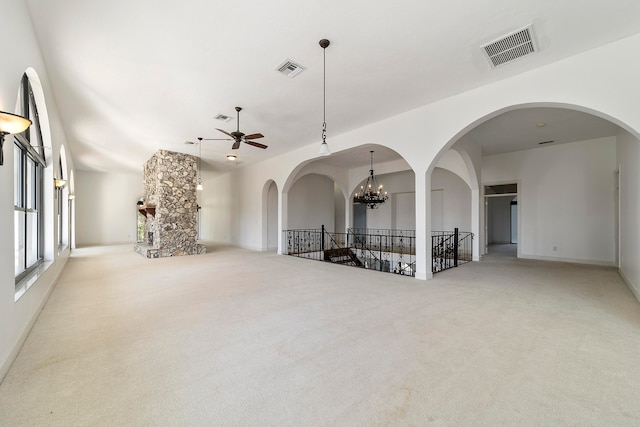 unfurnished room featuring light carpet and ceiling fan with notable chandelier