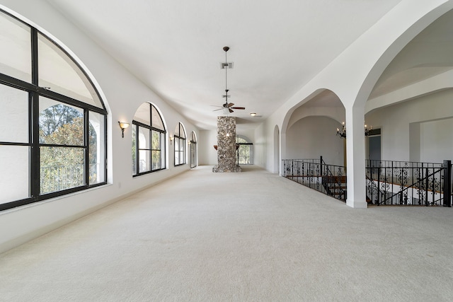 carpeted spare room with ceiling fan