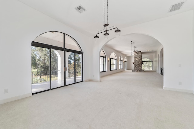 unfurnished living room featuring light carpet