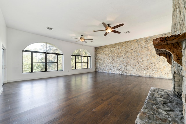 living room with ceiling fan, dark hardwood / wood-style floors, and a fireplace