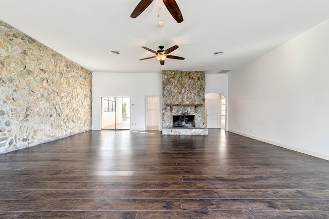 unfurnished living room featuring dark hardwood / wood-style floors, ceiling fan, and a fireplace