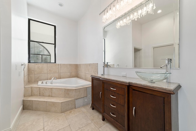 bathroom with tile floors, a relaxing tiled bath, and double sink vanity