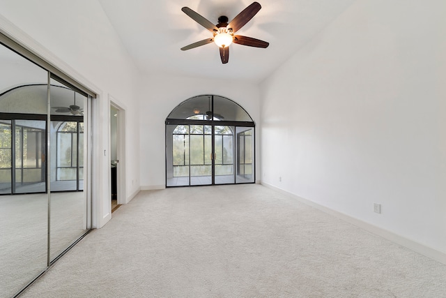 carpeted spare room with ceiling fan and a wealth of natural light