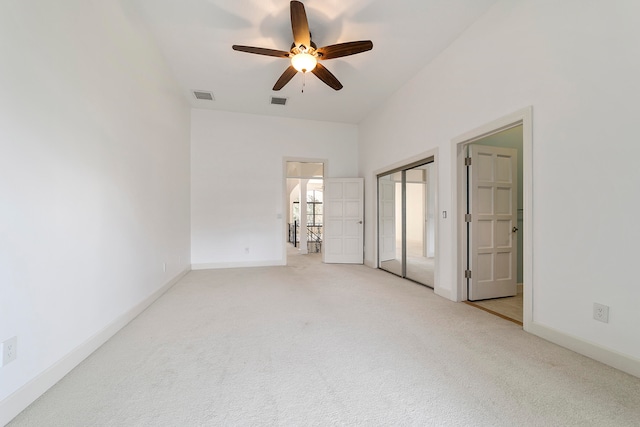 unfurnished bedroom with light colored carpet and ceiling fan