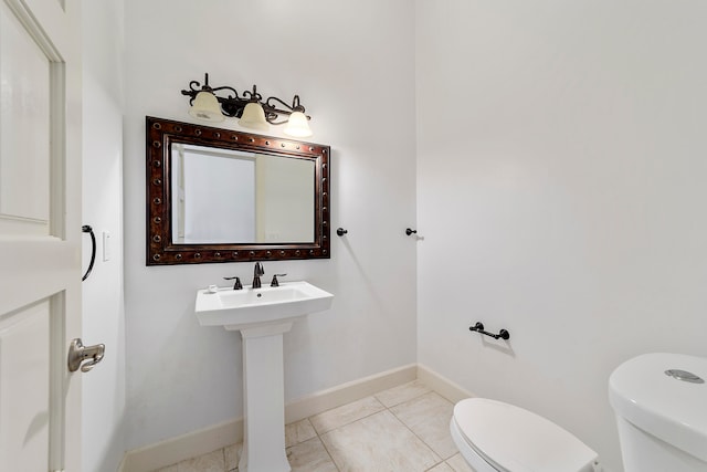 bathroom with tile flooring and toilet