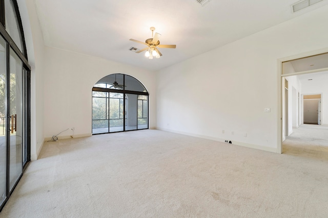 carpeted spare room with a healthy amount of sunlight and ceiling fan