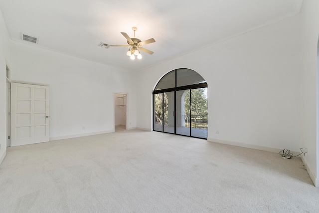 unfurnished room with light carpet and ceiling fan