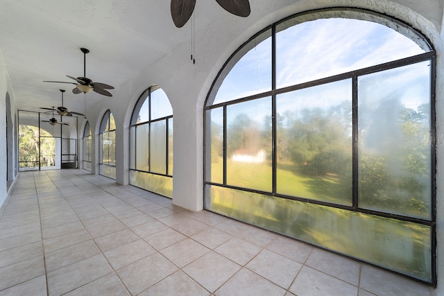 unfurnished sunroom featuring ceiling fan