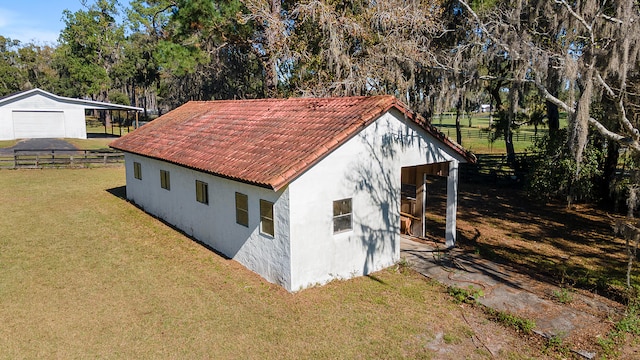 view of shed / structure featuring a yard and a garage