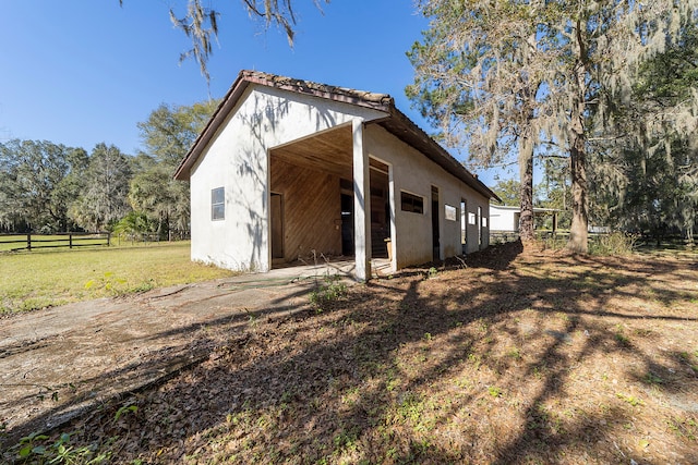 back of house with a lawn