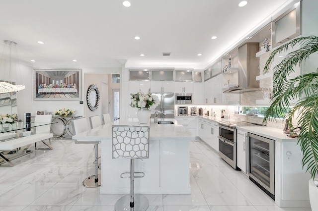 kitchen with a breakfast bar area, white cabinets, light tile floors, and wine cooler