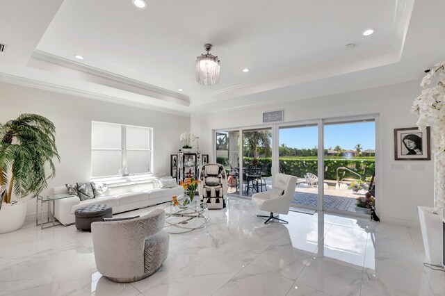 tiled living room featuring a chandelier and a tray ceiling