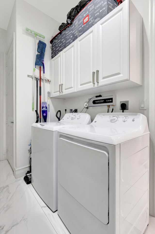 clothes washing area featuring electric dryer hookup, washer and clothes dryer, cabinets, and light tile floors