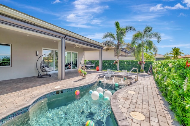 view of pool featuring a patio area and a hot tub