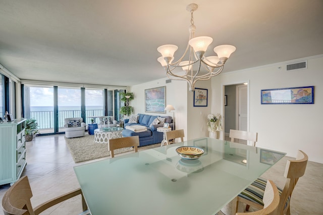 tiled dining area with floor to ceiling windows, an inviting chandelier, crown molding, and a water view