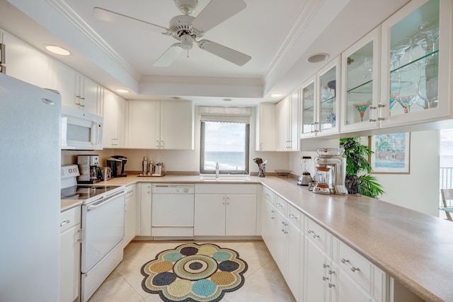 kitchen featuring white appliances, white cabinets, and ceiling fan