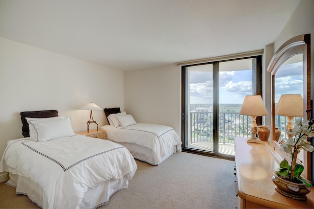 carpeted bedroom featuring floor to ceiling windows and access to exterior