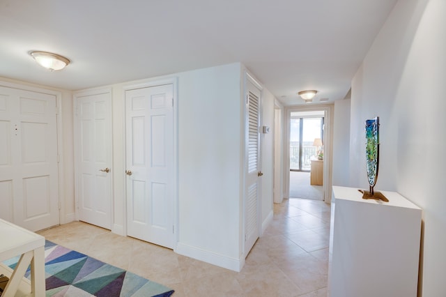 hallway featuring light tile floors