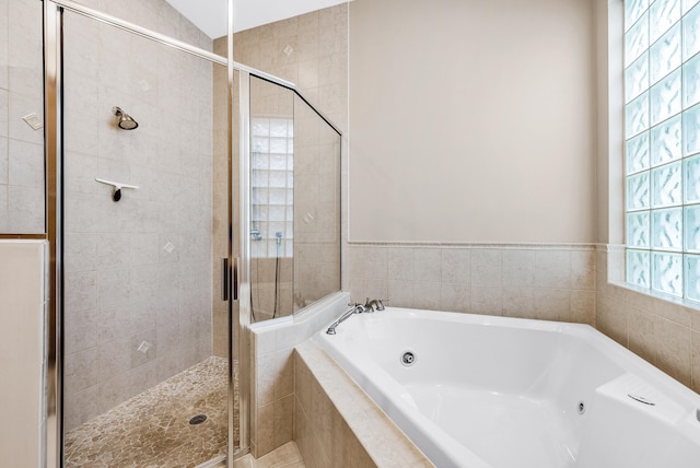 bathroom with separate shower and tub