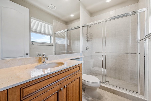 bathroom featuring tile floors, toilet, walk in shower, and oversized vanity