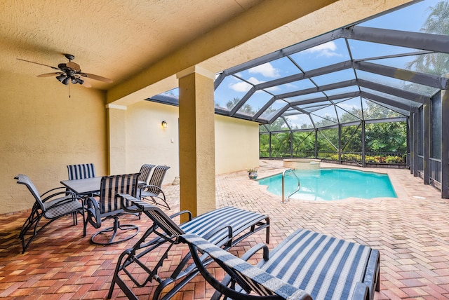 view of pool with a lanai, ceiling fan, and a patio area