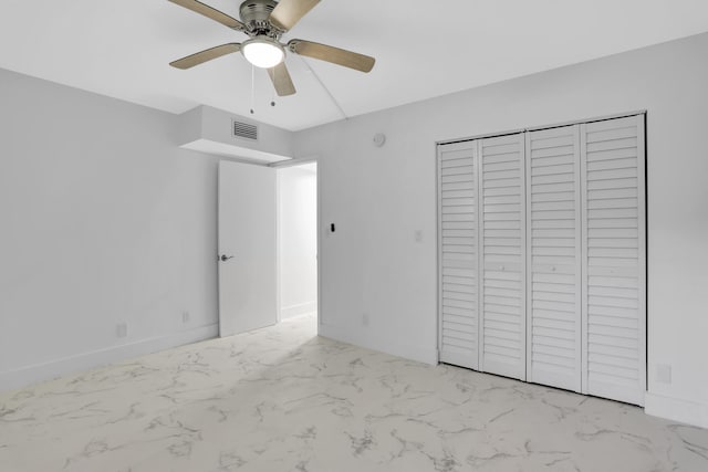 unfurnished bedroom featuring light tile floors, a closet, and ceiling fan