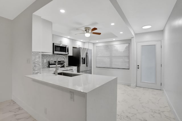 kitchen with white cabinetry, backsplash, ceiling fan, stainless steel appliances, and light tile floors