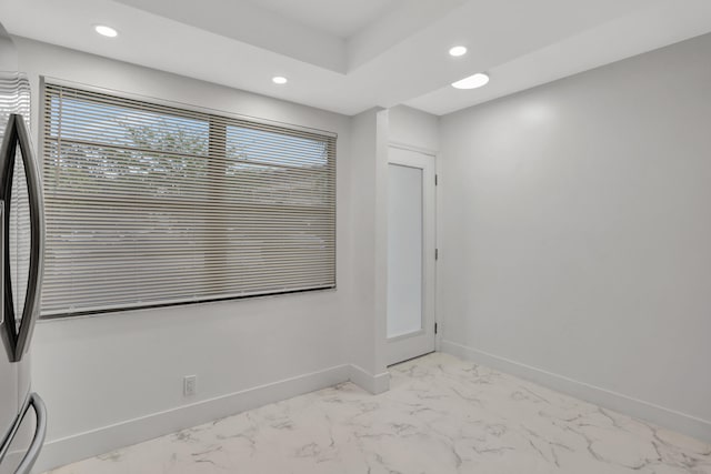 unfurnished room featuring light tile floors