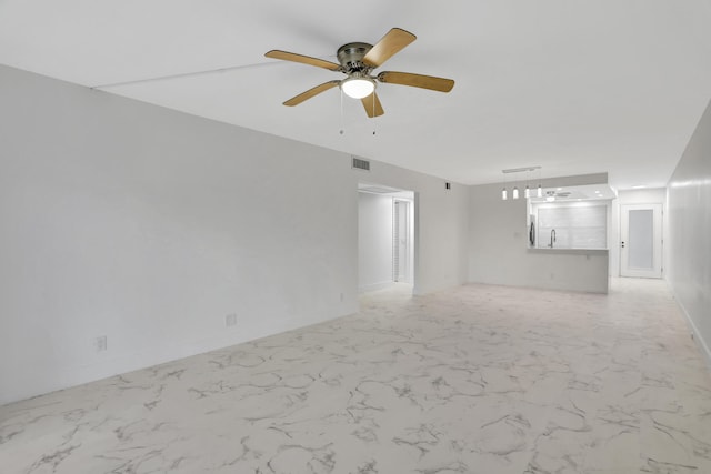 tiled spare room with ceiling fan and sink