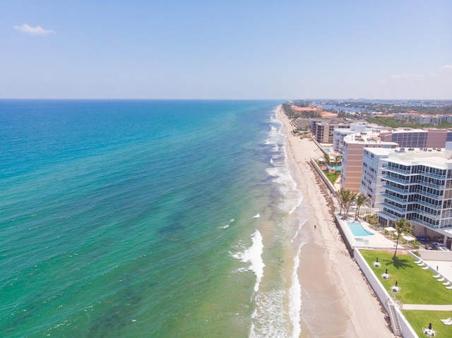 drone / aerial view with a water view and a view of the beach