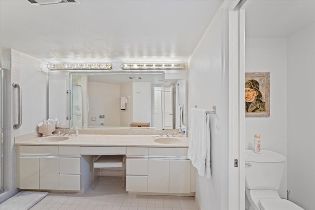 bathroom with toilet, a shower with door, tile floors, and double sink vanity