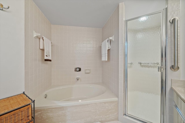 bathroom featuring plus walk in shower and vanity