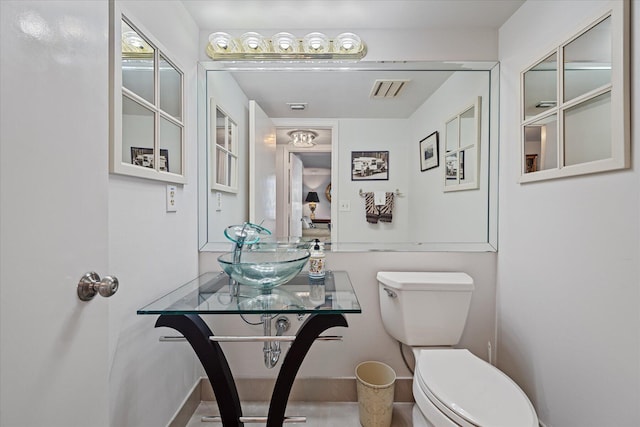 bathroom featuring toilet and sink