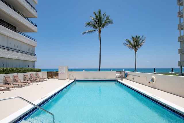 view of swimming pool with a water view