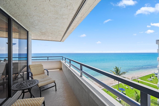 balcony with a view of the beach and a water view