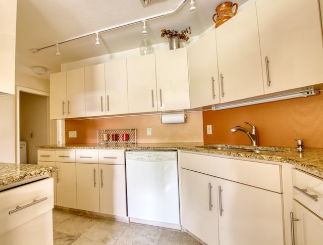 kitchen featuring white cabinetry, light stone countertops, dishwasher, sink, and track lighting