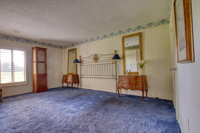 bedroom with carpet and a textured ceiling