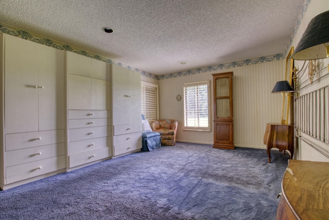 unfurnished room with carpet flooring and a textured ceiling