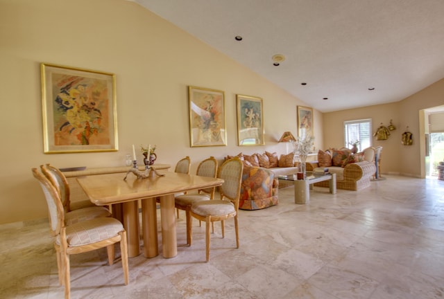 dining room with vaulted ceiling