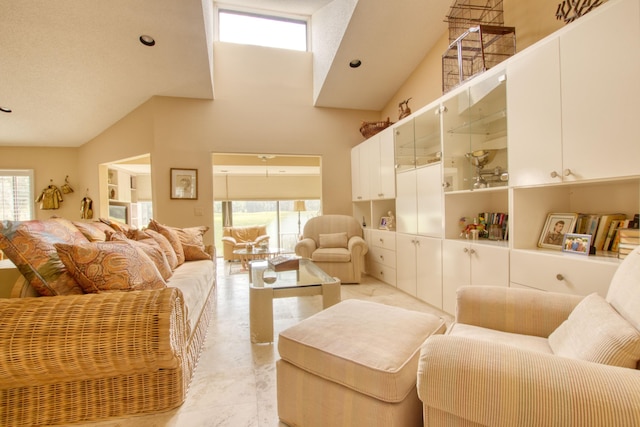 living room featuring high vaulted ceiling and a healthy amount of sunlight