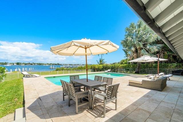 view of patio / terrace featuring a water view and a fenced in pool