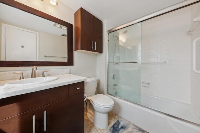 full bathroom with toilet, shower / bath combination with glass door, vanity, and tile flooring