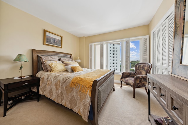 bedroom with light colored carpet and a closet