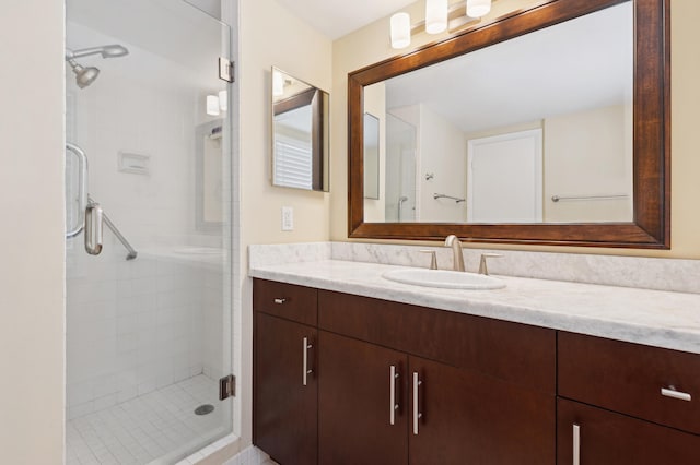 bathroom with walk in shower and vanity