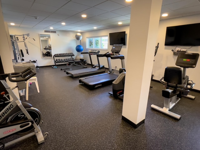 gym with a paneled ceiling