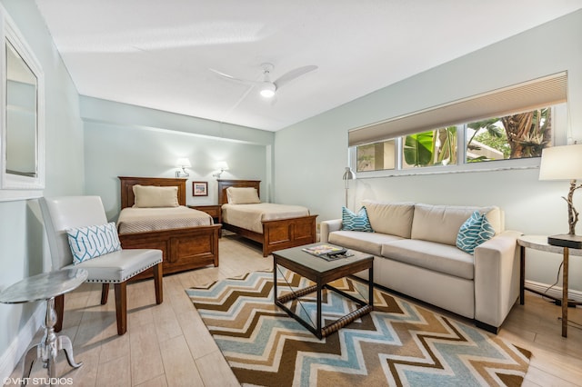 living room featuring ceiling fan and light hardwood / wood-style flooring